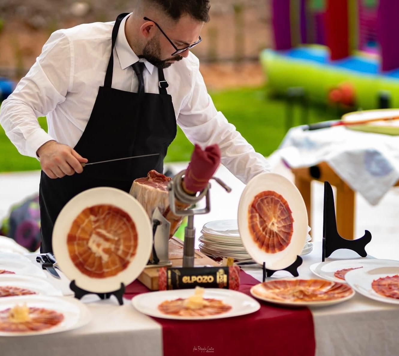 Adrián, cortador de jamón profesional, sirviendo lonchas de jamón ibérico en un evento en Murcia